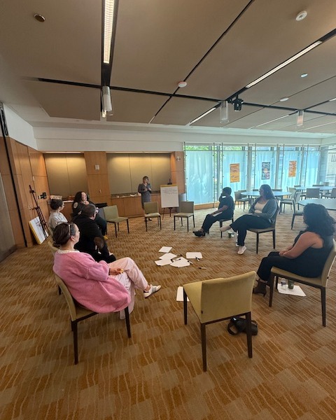 Students sitting in a circle discussing health and safety points for children.