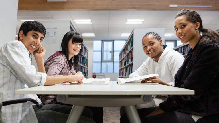 middle schoolers working together in the library