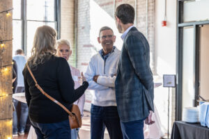 A group of people smiling and conversing. 